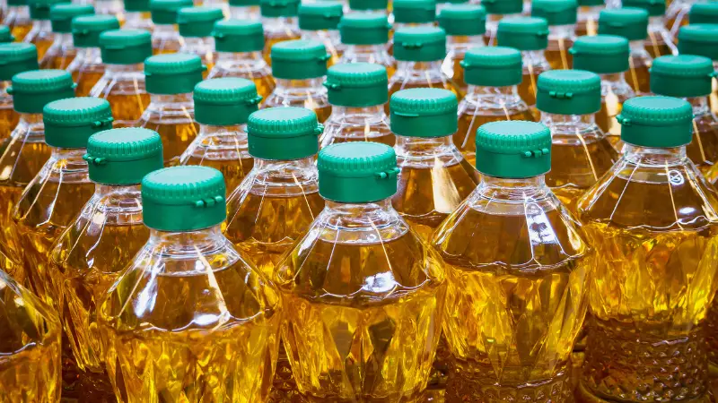 Bottles of yellow household cleaning liquid, representing chemicals commonly found in floor cleaners like Pine-Sol